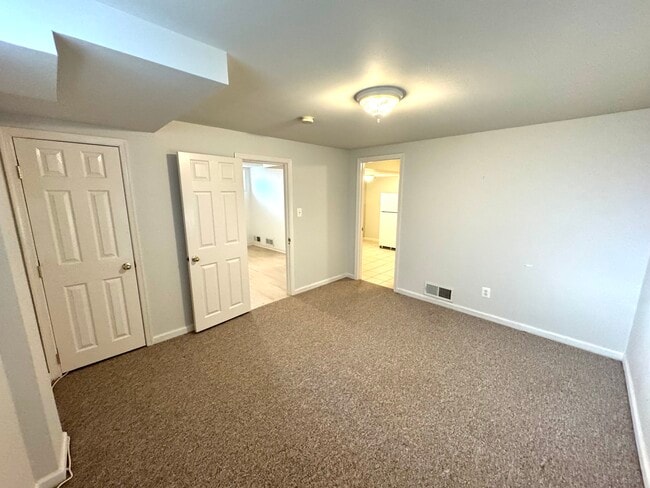 Bedroom or Living Room, with carpeting and closet - 201 E Indian Spring Dr Unit 1 - Yard - Utilities