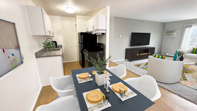 Gabinetes blancos elegantes, electrodomésticos de acero inoxidable o negros, pisos de tablones de madera. - Metropolitan Lafayette Flats