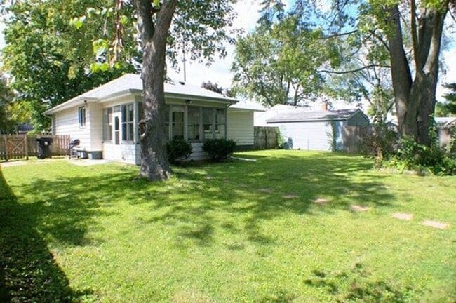 Photo - Corner Lot Charm: Spacious 3-Bed Home with Fireplace and Prime Location