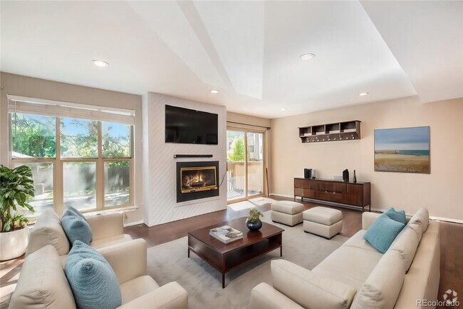 Living room with tons of space and natural light. - 701 Harlan St Unit E26 Rental