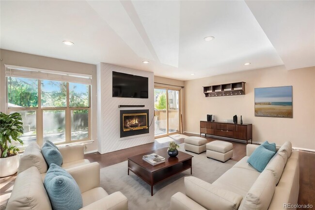 Living room with tons of space and natural light. - 701 Harlan St Condo Unit E26