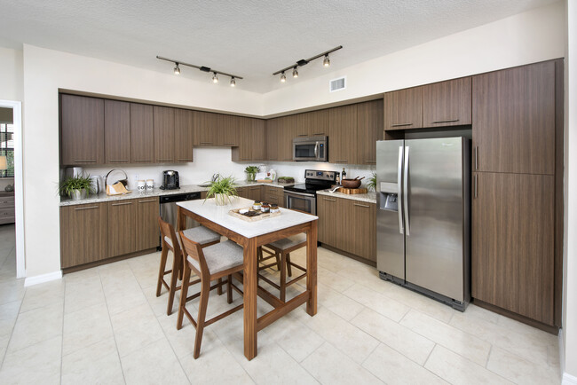 Kitchen with granite countertops, and stainless steel appliances - Avalon Toscana Apartments