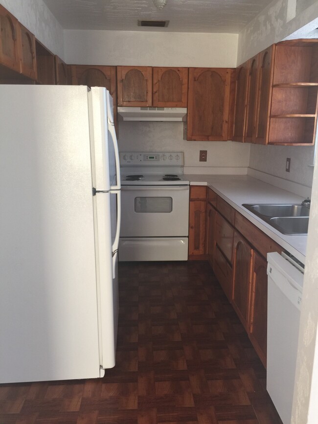 Kitchen. Fridge is pulled out. - 1875 Wabun Street Northeast Unidad Apt A