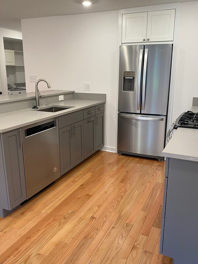 Kitchen includes gas stove, DW, microwave - 104 8th St NE Unit A