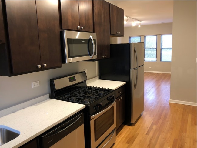 Modern Kitchen opens to living room - 3217 W Cullom Ave Apartments Unit 2
