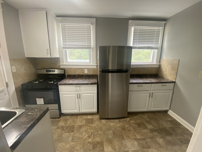 Kitchen with new stainless steel stove and refridgerator - 606 N Woodington Rd Apartments Unit 1