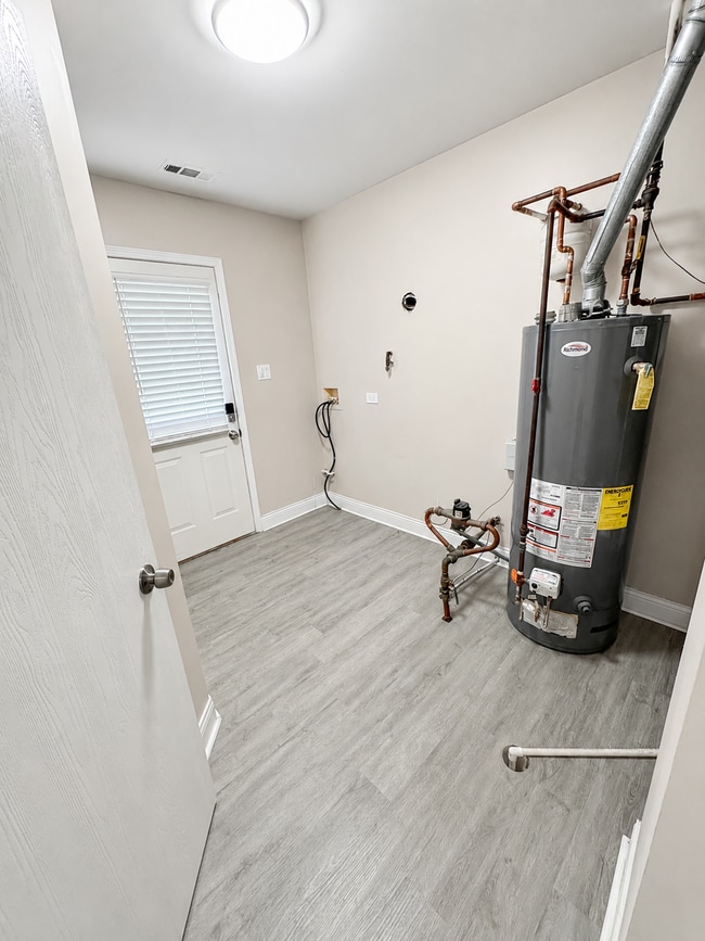 Photo - Updated 2-bedroom apartment with parking, front/rear access, modern flooring, full kitchen, and l... Unit C