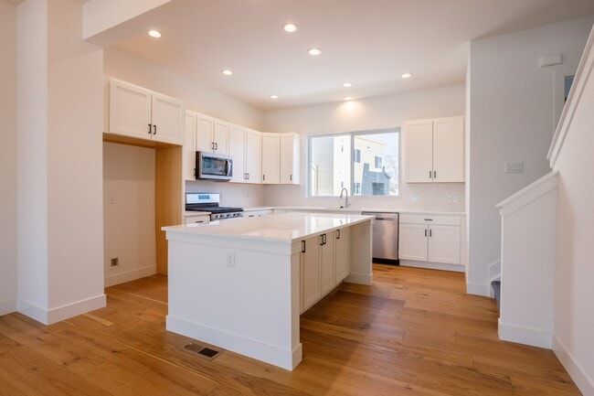 Kitchen with massive island and lot of cabinet space. - 888 S Valentia St Rental