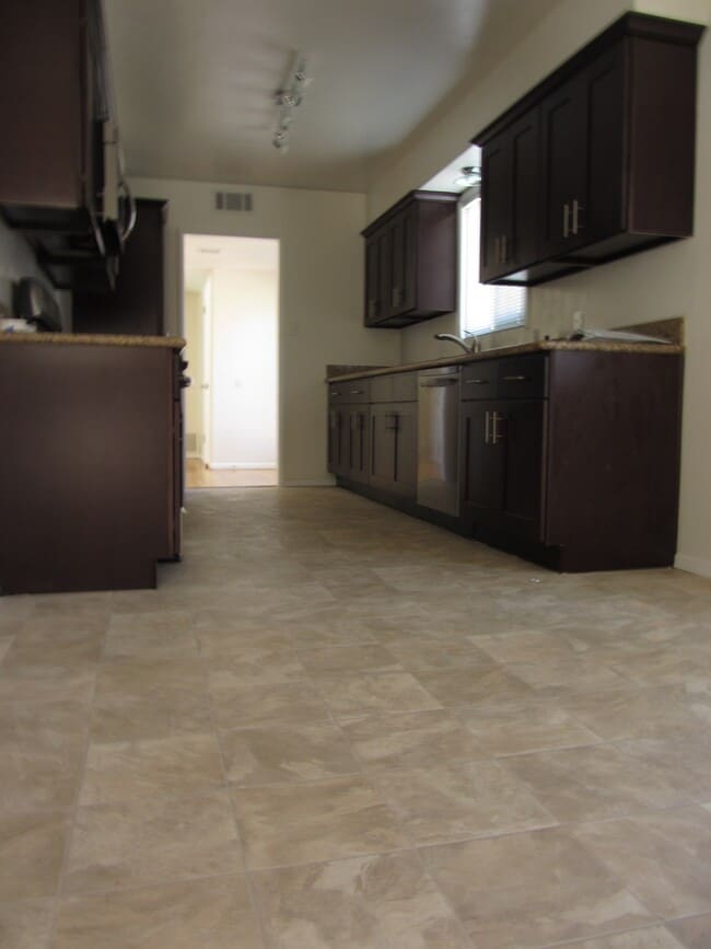Kitchen with tile floor and granite countertops - 1640 Dwight St