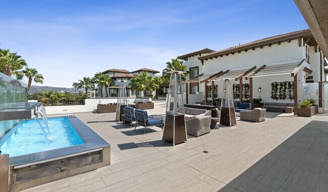 Rooftop deck exclusive to Penthouse residents features cabanas, covered fireplace lounge and bar area