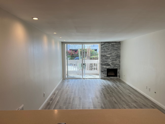 Functional main living space with stone ledger gas fireplace - 22 Navy St Unit 22 Navy St Apt 104