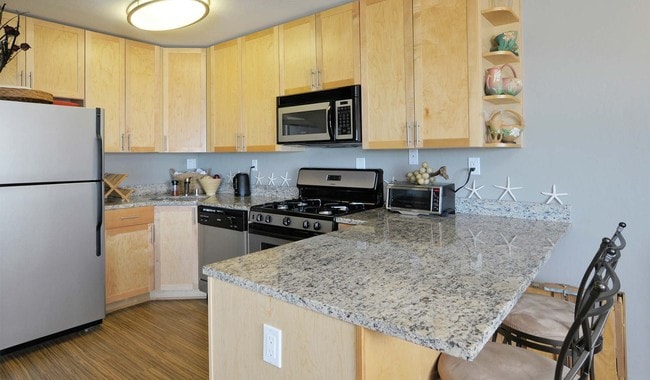 Kitchen includes stainless steel appliances and granite countertops