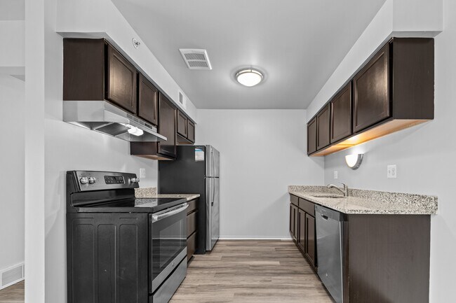 Upgraded Kitchen with stainless steel appliances and granite countertops at Westwood Village Apartments in Westland, MI - Westwood Village Apartments