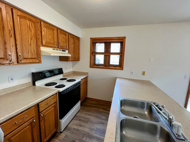 stove, double sink, and open connection to the main living space.