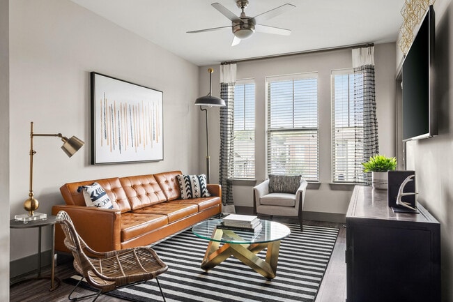 Experience the elegance of modern design in this inviting living room space. - The Sawyer at One Bellevue Place