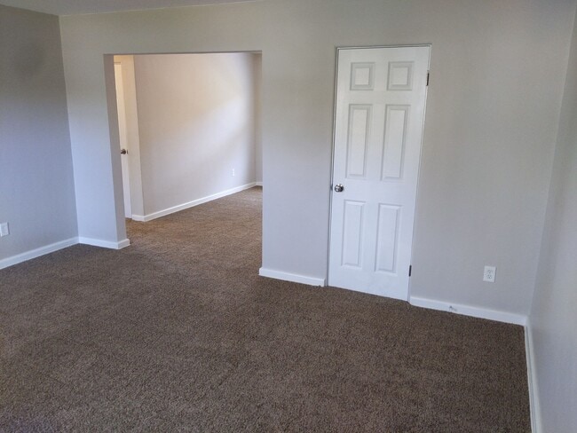 Living room looking toward dining room (front closet shown) - 1224 North Plum Street Unit Apt. 2
