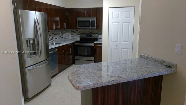Building Photo - 6195 NW 186th St Unit 417