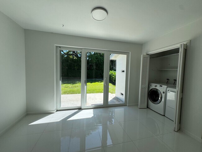 Triple wide hurricane proof doors leading out to large, landscaped, totally private backyard. - 11535 SW 81st Rd