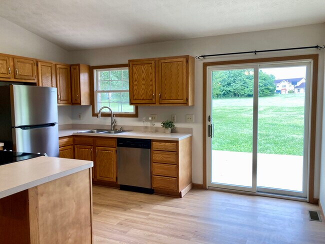 Kitchen with patio doors onto rear deck and view of yard - 778 B Calderwood Ct