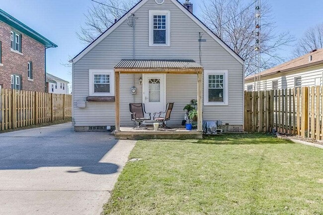 Backyard features fenced yard with covered porch, separate patio, 2 car garage and shed, along with plenty of space for parking