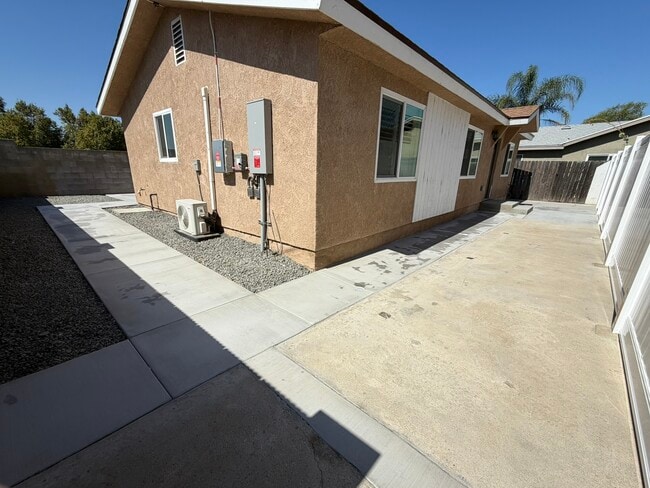There is a white fence dividing itself and front house