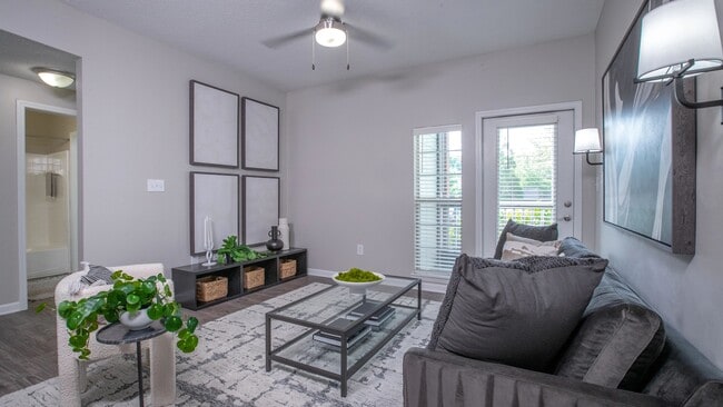 Find ultimate comfort in our living room, where a glass door invites you to a serene screened-in patio.