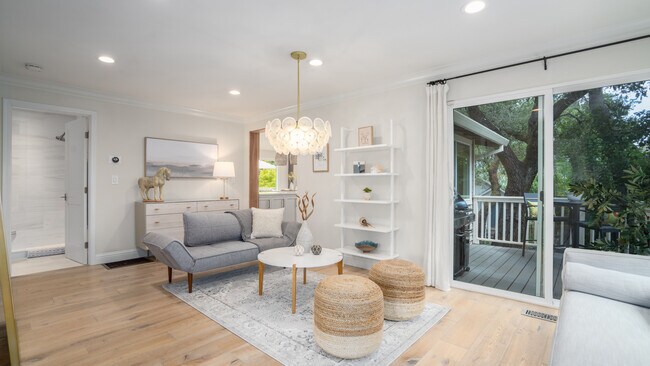 Las puertas corredizas de la cubierta crean un ambiente amplio y abierto en la espaciosa sala de estar. - 17320 Keaton Ave