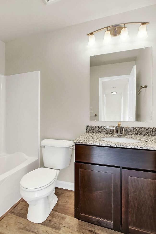 Experience sophistication with this elegantly designed bathroom, perfect for relaxation and comfort. - Hidden Meadows