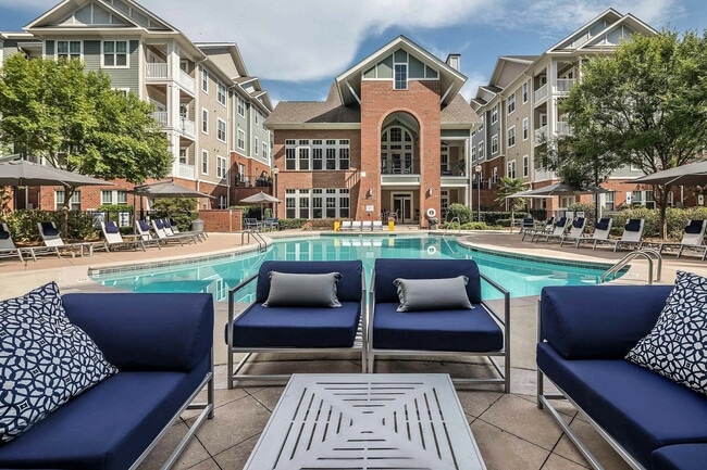 Resort-style pool with lounge seating, sundeck, and upscale clubhouse—luxury apartment living in Charlotte.