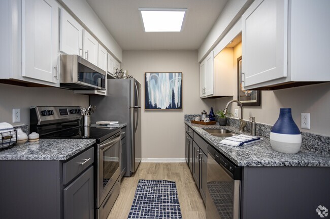 Kitchen with granite counters, stainless appliances, and modern cabinetry - Addison at Sutherland Rental