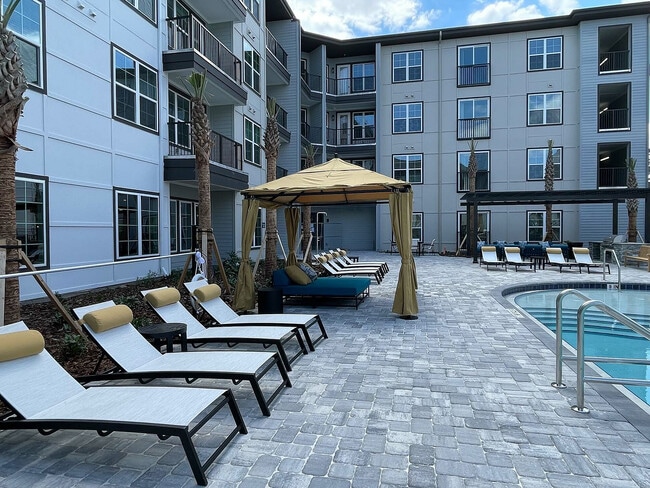 Relax in style at this modern apartment's chic poolside oasis.
