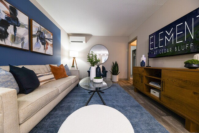 Step into comfort and style at Element at Cedar Bluff. This living room offers a perfect blend of modern design and cozy ambiance.