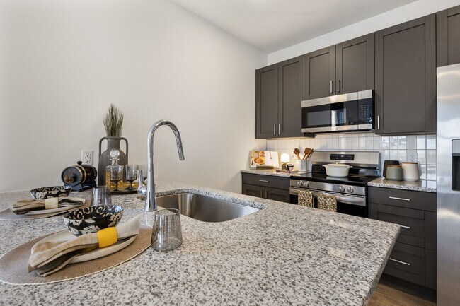 Modern apartment kitchen with island at Montage West Lafayette.