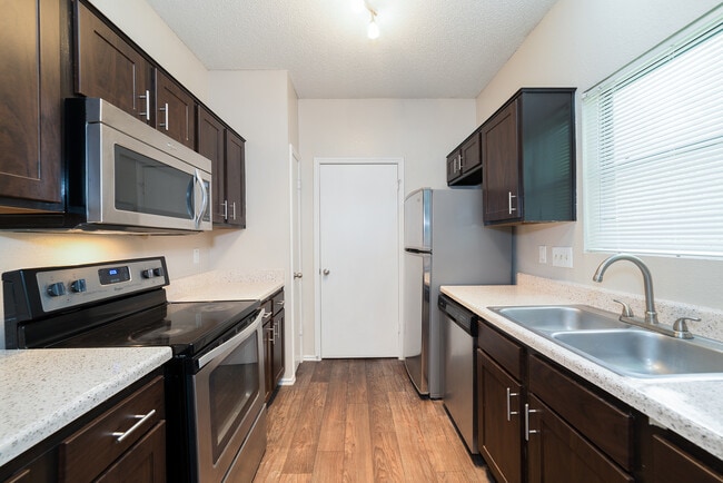 Updated kitchen with cherry wood cabinetry and stainless steel appliances