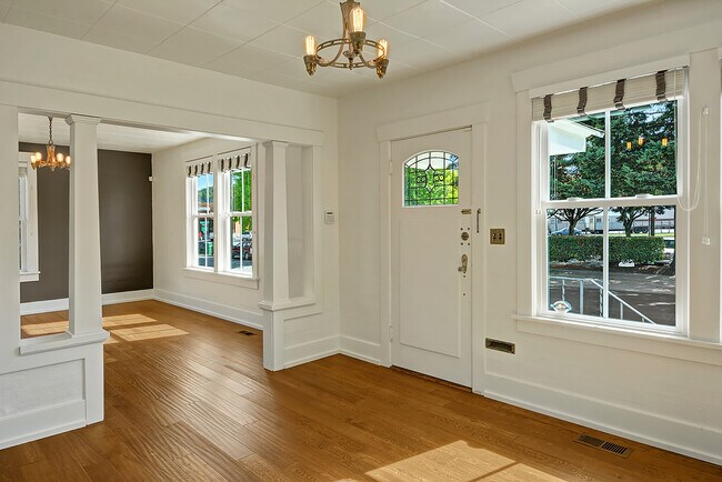 Large living/dining room with exposed hardwood floors. - 5403 Maynard Ave S