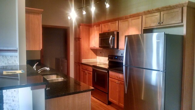 Kitchen with stainless appliances and granite - Hillstone Apartments
