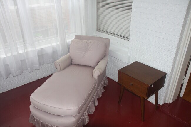 Enclosed front porch is really nice as a 3 season room. - 1415 W Rosemont Ave Apartment Unit 1E