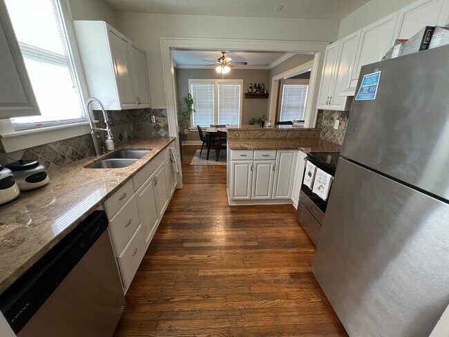 Kitchen includes stainless steel appliances, dishwasher, garbage disposal and a breakfast bar. - 14809 Leonard Ave Unit Down