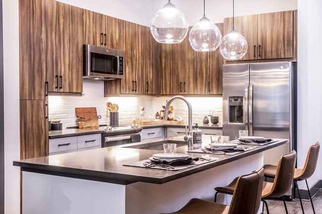 Our chef-inspired kitchens feature stainless steel appliances and side-by-side refrigerators. - Windsor Interlock Apartments