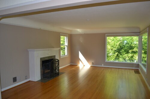 Beautiful natural light as seen in the living room. Fireplace is now gas.