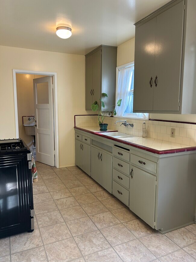 Kitchen (with private laundry room) - 111 1/2 N 6th St Apartments Unit 0