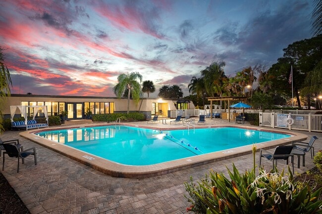 Resort style pool with lounge chairs and umbrellas
