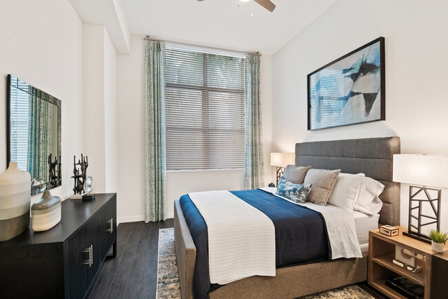Bedroom with ceiling fan and hard-surface vinyl plank flooring