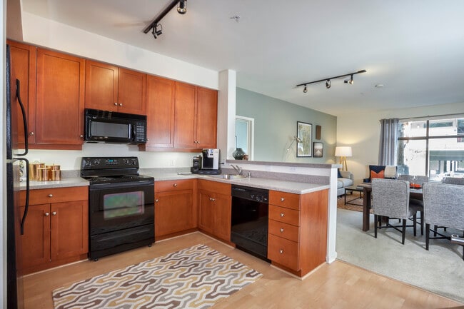 Classic Package I kitchen with black or white appliances, cherry cabinetry, laminate countertops, and hard surface flooring
