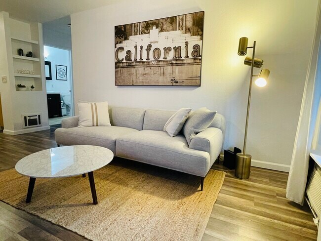 Living room with Roku tv for streaming wall ac in living room - 6386 Rancho Mission Rd Unit 307