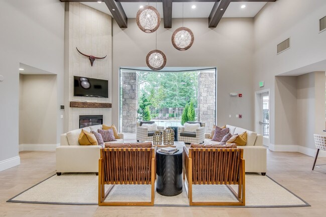 Newly renovated clubhouse with lounge furniture and fireplace - The Estates at Cougar Mountain