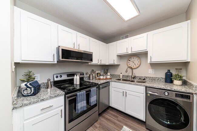 Kitchen with granite counters, stainless appliances, and modern cabinetry