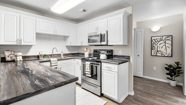 Whip up culinary masterpieces in a gleaming kitchen with abundant storage and modern appliances.