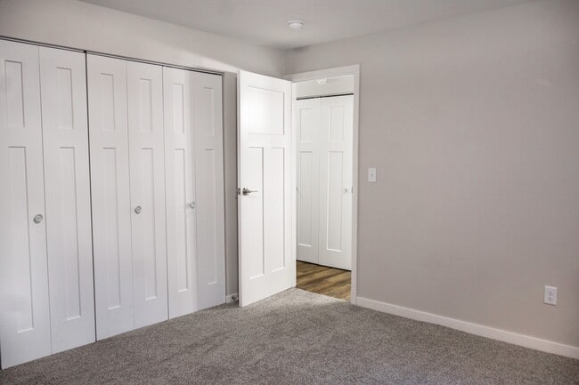 Step into modern comfort at The Gallery. This spacious bedroom features ample closet space and a serene ambiance, perfect for relaxation. Elevate your living experience today! Schedule a tour to see it for yourself. - The Gallery Apartments