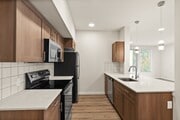 A sleek kitchen design featuring stainless steel appliances, quartz counters, and stylish pendant lights.